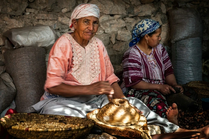 a man and a child sitting next to a basket of food